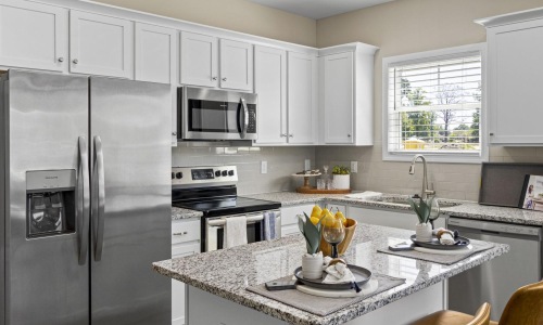 a kitchen with white cabinets