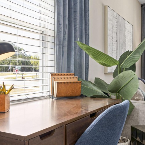 a naturally lit room with a table and chairs