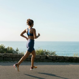 a girl running near a beach