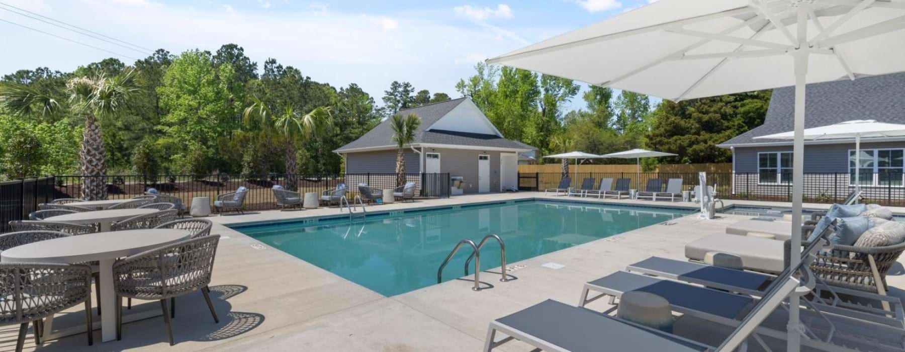a swimming pool with a white umbrellas