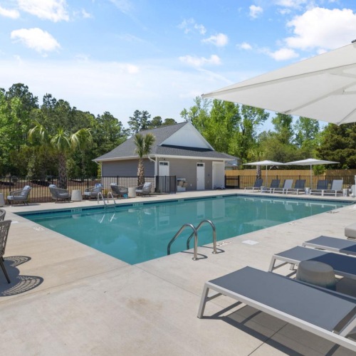 a swimming pool with a white umbrellas