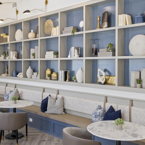 a room with a white wall and shelves with objects on it