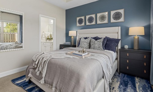 a bedroom with a bed and lamps
