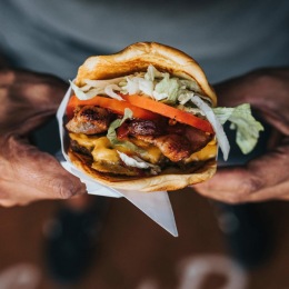 a man holding a burger