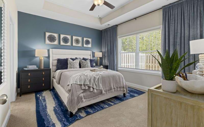 a naturally lit bedroom with high ceilings and a fn